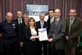 Jan Rowley from Liverpool City Council presents the Award to Adam Hebden GMFRS Environmental Manager and Councillor Paul Ankers GMFRA Member Champion for the Environment (third from right) along with other representatives from the NW Fire & Rescue Services
