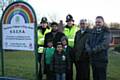 Shahid Mohammed (centre) with the people who have worked to have the sign put in place, accompanied by children who use the play area