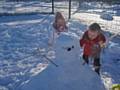 Sure Start children Lucy Fraser and Jay Anderson busy building their snowman at Langley Children's Centre.