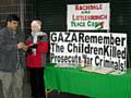 Dr Farrukh Zia with peace group member Pat Sanchez signing the petition to end perceived war crimes in Gaza.