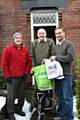 Elderly resident Roger Wareing receives a food parcel from Paul Gala and Lyndon Price of Age Concern.