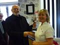 Janet Rawlinson being presented her trophy by Steve Lister 