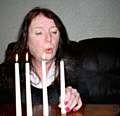 Kerry Reddy, Manager at Rochdale’s Omega Women’s Centre, extinguishes one candle that represents a domestic abuse victim this Christmas