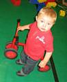 Toddler Leighton Wilson enjoying the trikes