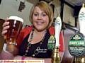 MINE host . . . Sarah Tetlow raises a pint as the new landlady at the Tandle Hill Tavern 