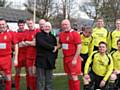 Ian Jenkins of Springhill Hospice shakes hands with Sacred Heart FCs Mick Stott