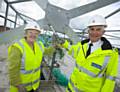 Gloria Oates, Vice Chair GMPA and GMP Chief Constable Peter Fahy screw in golden bolt 