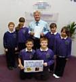 Headteacher Danny Mulkeen with pupils from Sandbrook Community Primary