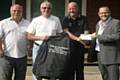 Tony Rollins handing over a cheque and jacket to Andy Mather, Dave Hughes and Mick Hart from Bamford Bowling Club.