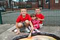 Christopher, Julia and John Wild enjoy the outdoor messy play time