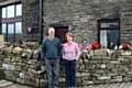 Norman and Jean Molyneux outside the cottages at Fielden Farm