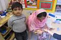 One visitor having mendhi decorations applied
