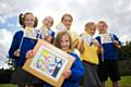 Lucy and her friends celebrate with the winning flag design 
