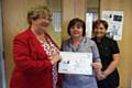 Suzanne Allison receives her award from Non-Executive Diane Hardwick, along with nominator Gillian Tandy 
 
