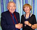 Retiring President Harry Muncaster hands the chain of office to Patricia Noon. 
Photograph courtesy of Bob Srinivas.
