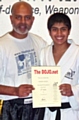 Issmaeel Ansari receiving his third dan certificate from Chief Instructor of The DOJO Karate Centre, Sensei Irfan Ansari