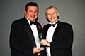 Mike Goldrick (left) accepting his Businessman of the year award from Vice Principal of Hopwood Hall College John Spindler

