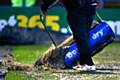 Dale ground staff removing water from the water logged pitch