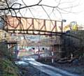 The remnants of the Harbour Lane North Bridge in Milnrow, looking down the old trackbed, towards Newhey and Oldham.  View from the Elizabethan Way bridge abutments.
