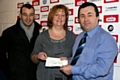 Dean Connaughton, Community Fundraiser for Springhill Hospice and Sarah Ford, Income Services Lead for Springhill Hospice receive the cheque from Chief Executive of Rochdale AFC, Colin Garlick.