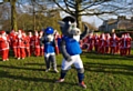 Rochdale AFC club mascots Desmond the Dragon and Desmond’s son Dale warm-up the Santas