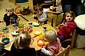 The children enjoying spring rolls, rice, chicken and prawn crackers.  
