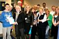 Members of the Rochdale Connections Trust with guests celebrating their Annual Report and Deputy Mayor Alan Godson presenting Daniel Hutton with a certificate