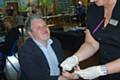 Councillor Dale Mulgrew getting a health check from one of the staff from the Kirkholt medical practice