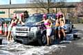 The ladies cleaning a car for charity