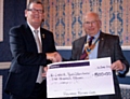 Terry Dean accepts the cheque from John Cannell