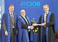 Kieren McDonnell, Operations Directors and Graham Jackson, Managing Director, receiving the CIOB certificate. 
