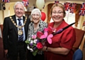 Mayor Godson and Carol Matthews presenting Edith Duckworth with a bouquet of flowers