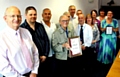 Volunteers accept their award: (left to right) Chairman John Schofield, Tony Wardle, Paul Gormley, Johnny Barlow, Jack Grimshaw, Colin McKinless, Jim Gosney, Michael Garside, Allison Byrne, Lillian Yates, Karen Byrne, Janet Hinkley.  
