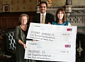 Doreen Stott from Parkinson’s UK Rochdale branch and Michelle Hollinrake, Manager of Shopmobility, accept their cheques from Councillor Zulfiqar Ali 