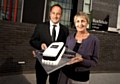 Rochdale Sixth Form College's Principal Julian Appleyard and Chairwoman of the governing body, Dame Pamela Coward, with a first birthday cake