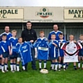 The team recieving their sponsored kit as well as a signed Salford City reds shirt as a prize from Matt Gilks