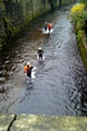 A BBC film crew make their way under the River Roch bridge in the town centre