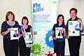 Staff at The Pennine Acute Trust’s Occupational Health Department with Flu campaign material