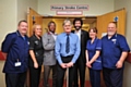 Kevin Griffiths (centre) with the medical team he credits with saving his life. L- R Stuart Greenwood, Charge Nurse A&E, Cath Curley, Stroke Thrombolysis Co-ordinator, Dr Robert Namushi, Stroke Consultant, Kevin Griffiths, Patient, Dr Khalil Kawafi, Stroke Consultant, Denise Knowles, Ward Manager at the Acute Stroke Unit and Stuart Young, Ward Manager for Stroke Rehabilitation.
