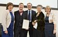 Dr. Sean Pert (second from left) accepts the award with Carol Stow (fourth from left) looked on by the Deputy Chair of the Royal College of Speech and Language Therapists (RCSLT) Maria Luscombe, RCSLT President Sir George Cox and RCSLT Chair Bryony Simpson