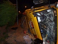 Firefighters freed a man who was trapped in a gritting lorry after it collided with a house and overturned in Rochdale