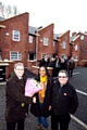 Hill Street resident Miss Marjorie Mutemasango is presented with flowers by Guinness Northern Counties’ Director of Neighbourhood Services John Cockerham (left) and Councillor Peter Rush.
