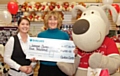 Clintons Rochdale Store Manager, Natalie Hewitt, presenting the cheque to Joanna Butterworth with Boofle