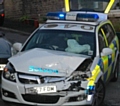 The damaged police car at the scene of the collision 
