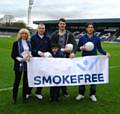 Ve Nutter, Health Improvement Officer at Rochdale Borough Council, with players from Rochdale AFC and front, Zareb Siddiqui