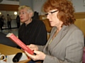 Tricia Hornby Chief Executive of Rochdale & District Mind looking at a copy of ‘I Capture the castle’ with Kevin Shepherd in the background