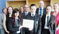 Pupils and staff (including Head Teacher John Watson in centre and Neil Coe to his right) celebrate their success