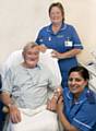 Patient Councillor David Barnes, Mayor of Whitworth, with Wendy Wood, staff nurse, and Sister Naheed Sabir