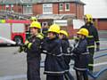 Young people perform fire and rescue demonstrations for their families at a passing out parade after completing an anti-social behaviour course at Rochdale Fire Station over the school holidays