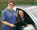 Eileen Taylor, Chairperson of Rochdale’s Institute of Advanced Motorists, presents Eric Buckley with a Gold Certificate following his assessment drive